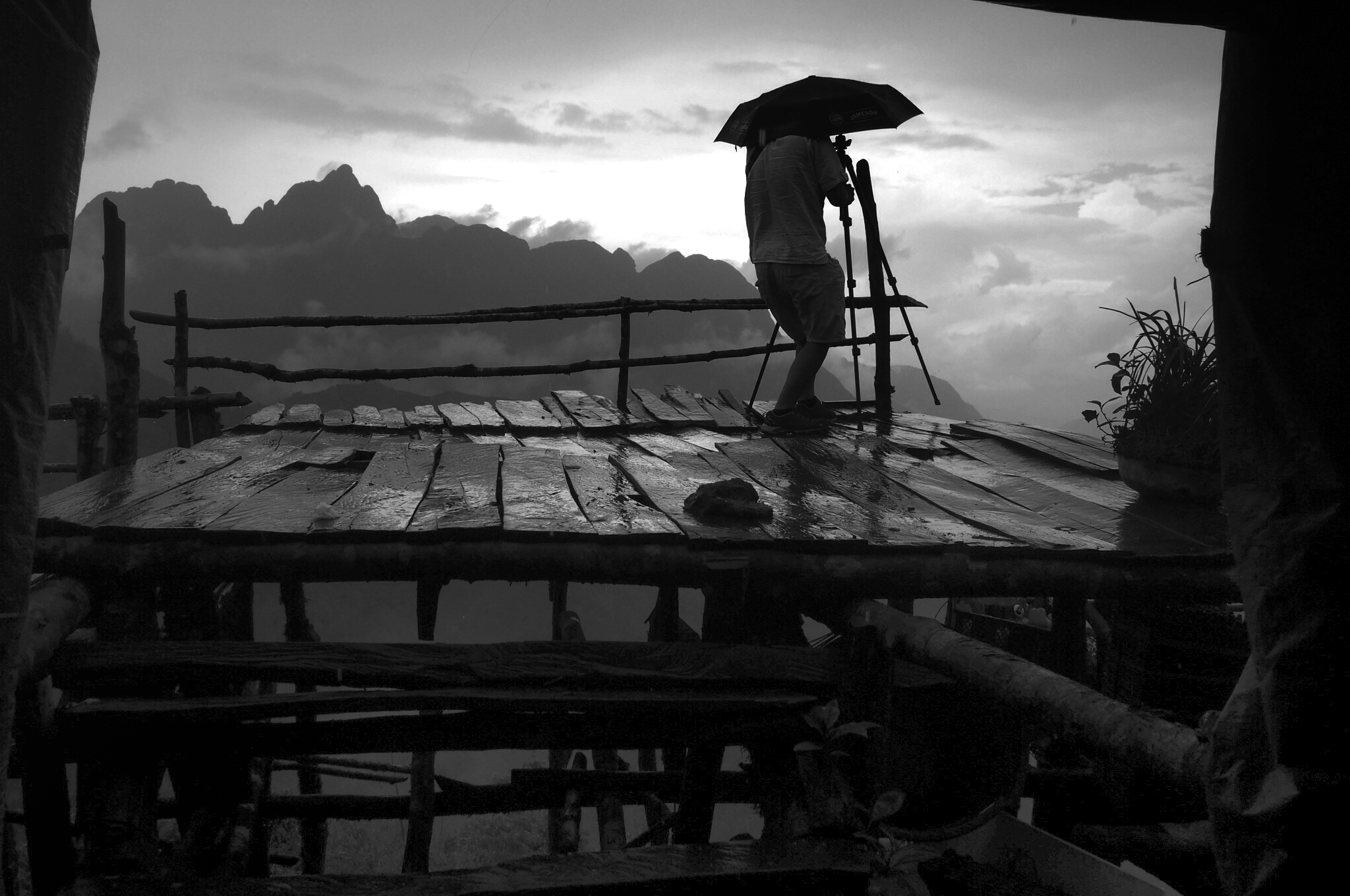 photographer shields himself from the rain in Sapa, northern Vietnam