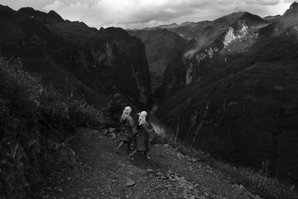 two children walking down a mountain path in Ha Giang, northern Vietnam